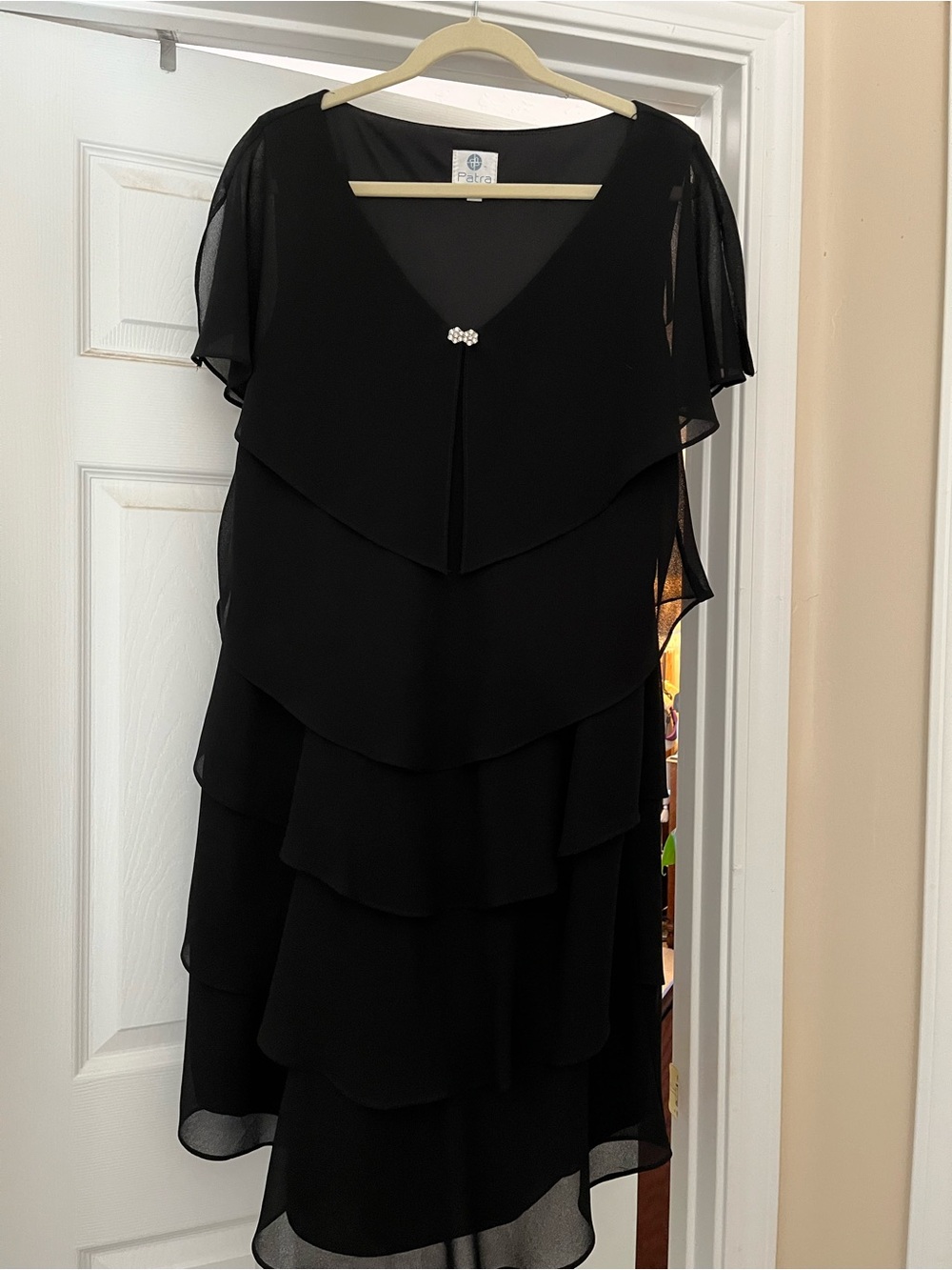 Patra Black Layered and Flowy Cocktail Dress with rhinestone brooch.